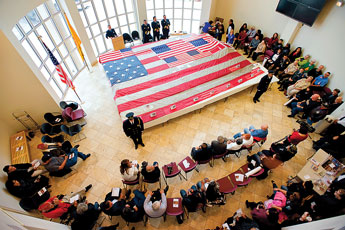 The Flag Stitching Ceremony commences in the rotunda of the McKinley County Courthouse on Thursday morning. The flag, which was flying near the World Trade Centers at the time of Sept. 11 attacks, is traveling the country and at each stop members of the community put another stitch in the flag. © 2011 Gallup Independent / Brian Leddy 